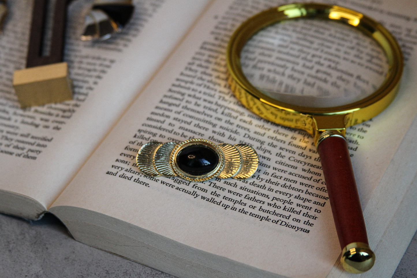 Aiwan Golden Orbit Brooch with Black Stone Center